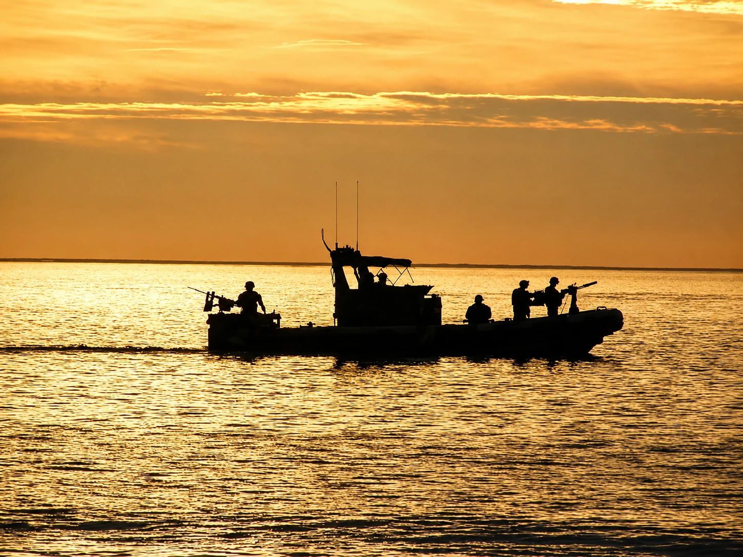 Small Unit Riverine Craft underway at sunset on Lake Haditha, Al Anbar Province, Iraq, 2005